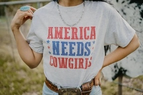 Tagless Design America Needs Cowgirls Tee